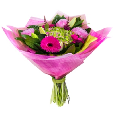 Dreamland - Bursting with pink flowers and fabulous handtie including florists selection of stems.
