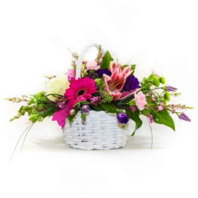 A Basket that Delights - A delightful basket arrangement of pinks, creams and purple mixed with complementary foliage.
