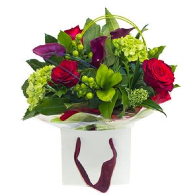 Roses In The Garden - A classic design with a modern twist featuring bright bold red roses and exclusive spring flowers placed in sereen foliage. An ideal gift to show you really care.
