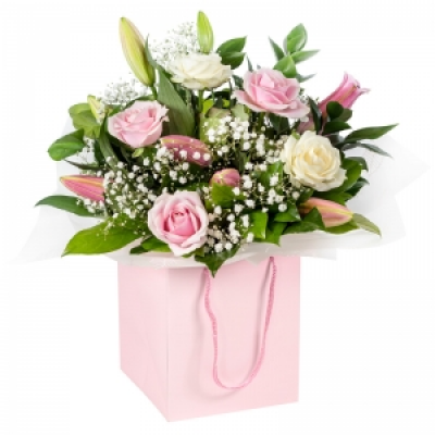 Strawberries & Cream - A beautiful collection of roses and lilies hand-tied and delivered in a gift bag or box.
