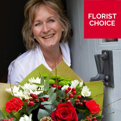 Christmas Florist Choice Hand-Tied - A festive hand-tied filled with the seasonal flowers, perfectly wrapped by the local florist and delivered in water.